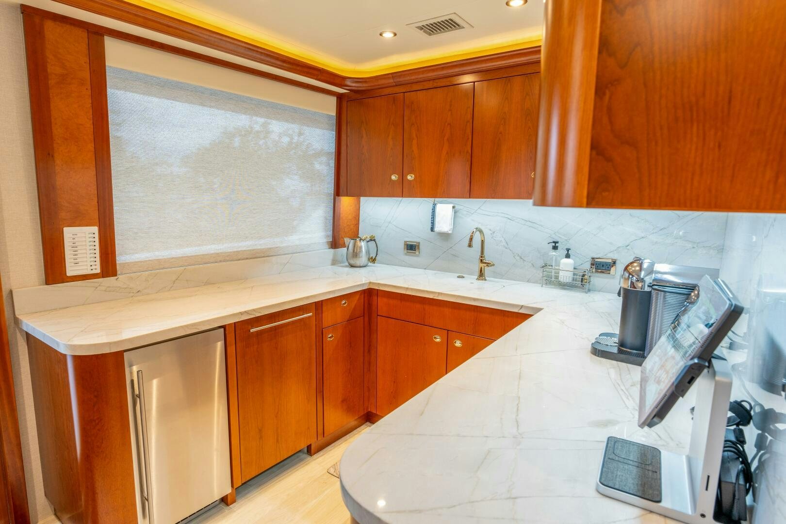 a kitchen with wooden cabinets aboard RELENTLESS Yacht for Sale
