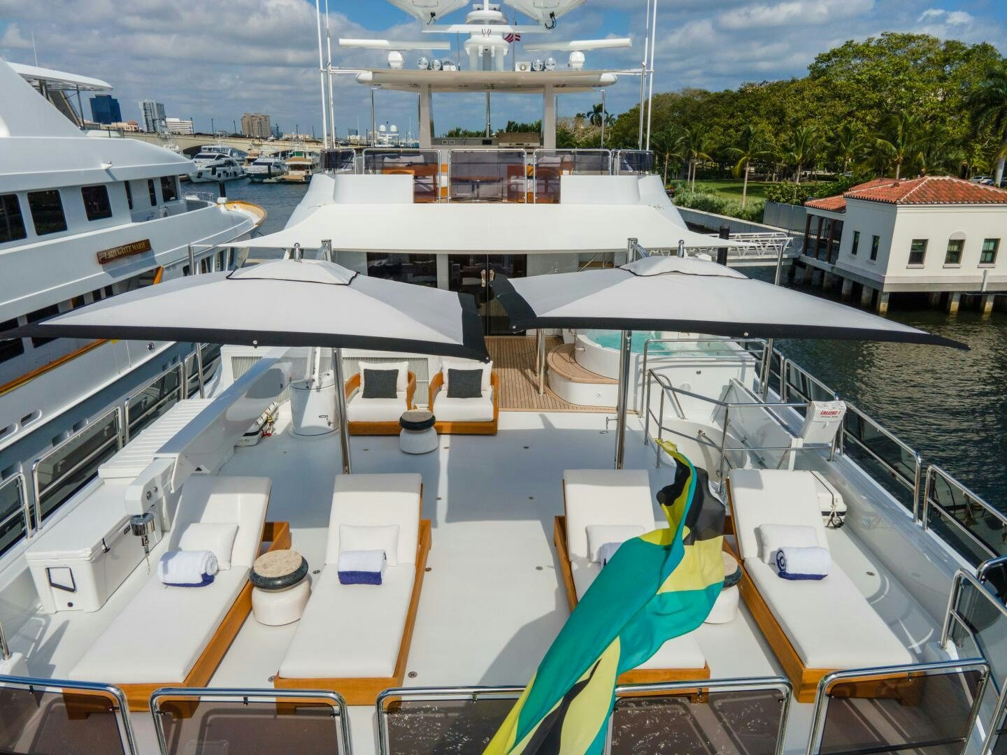 a deck with boats and a building in the background aboard RELENTLESS Yacht for Sale
