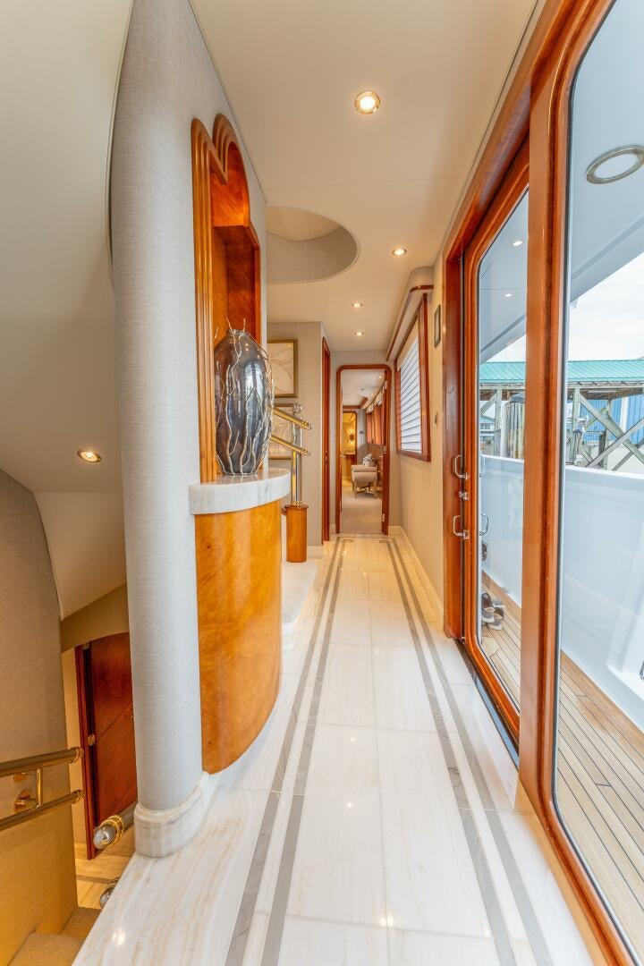 a hallway with a door and art on the wall aboard RELENTLESS Yacht for Sale