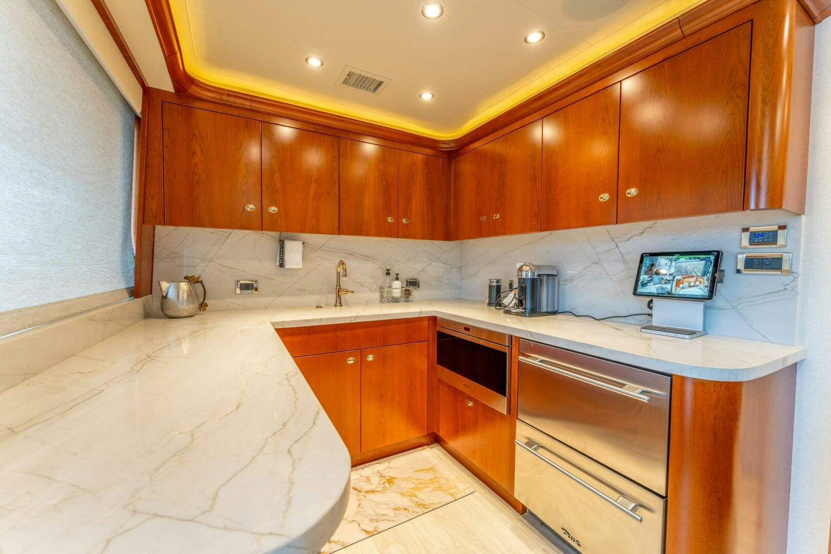 a kitchen with wooden cabinets aboard RELENTLESS Yacht for Sale