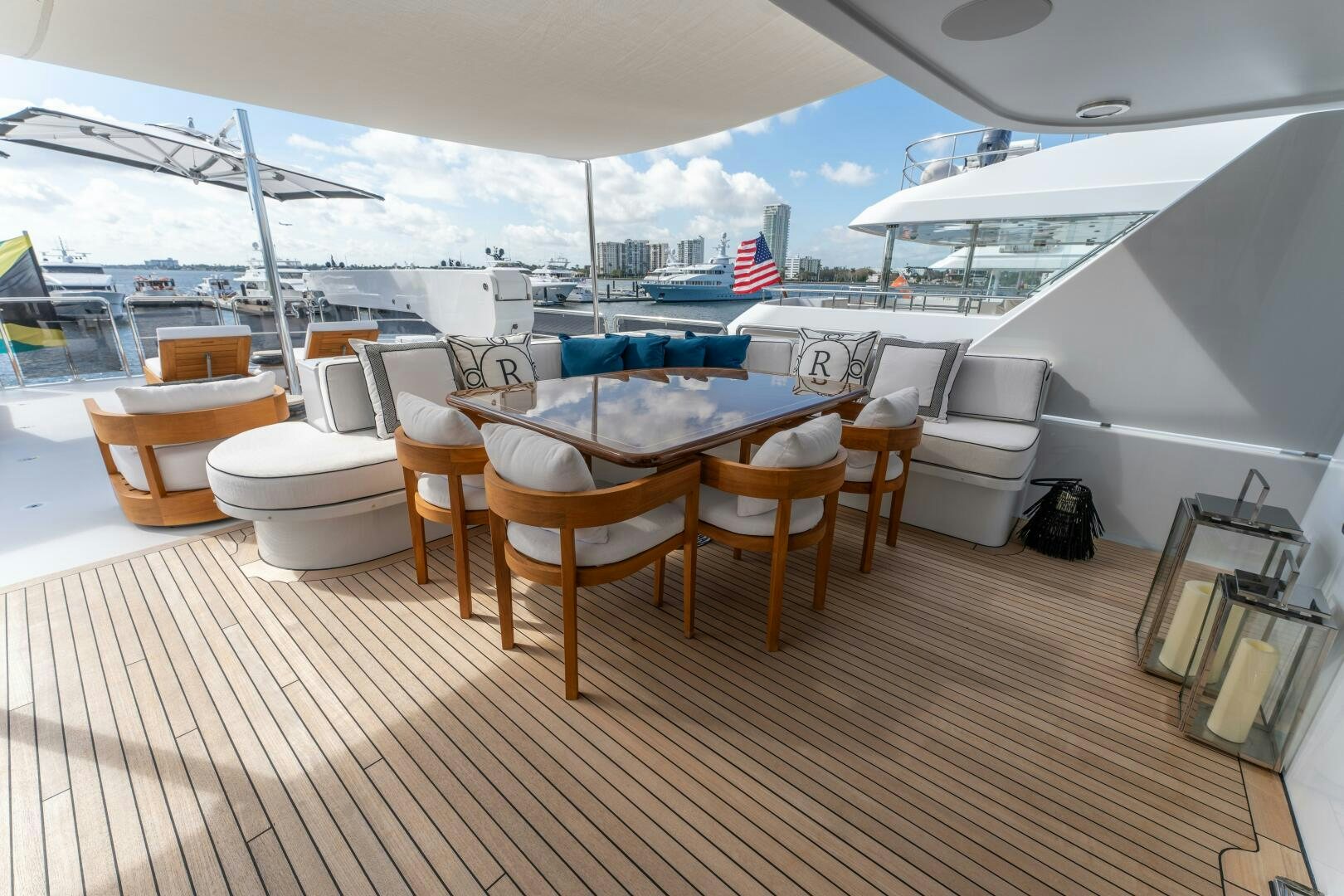 a wooden deck with tables and chairs on it aboard RELENTLESS Yacht for Sale