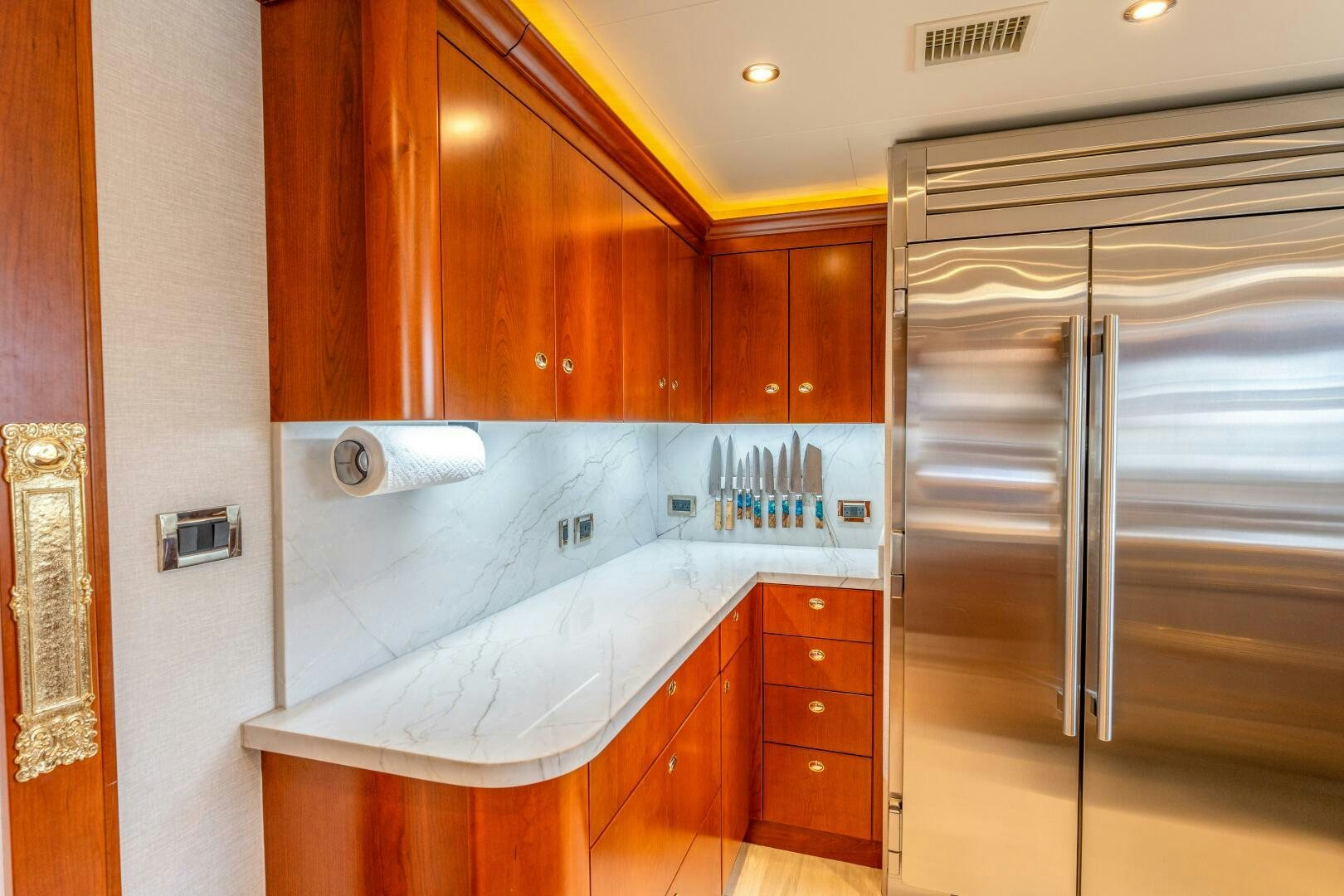a kitchen with a refrigerator and a sink aboard RELENTLESS Yacht for Sale