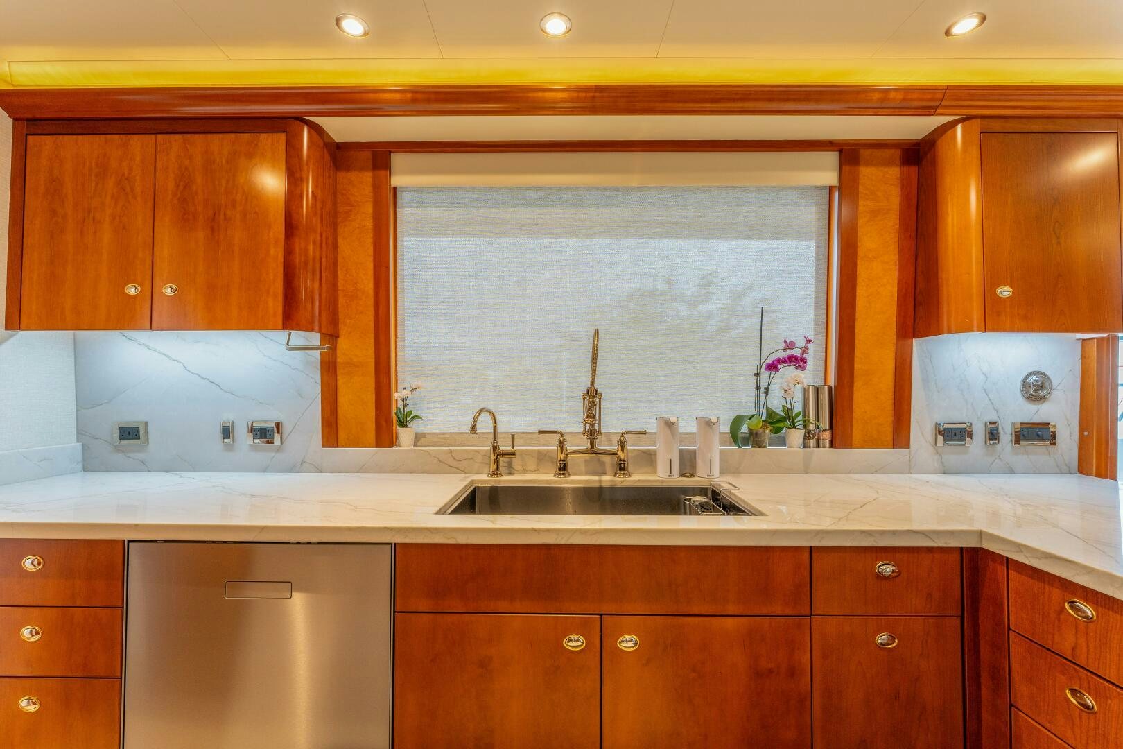 a kitchen with wooden cabinets aboard RELENTLESS Yacht for Sale
