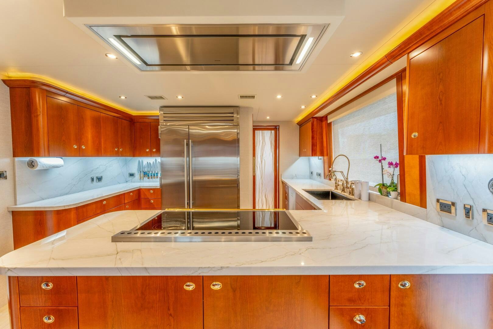 a kitchen with a large stainless steel refrigerator aboard RELENTLESS Yacht for Sale