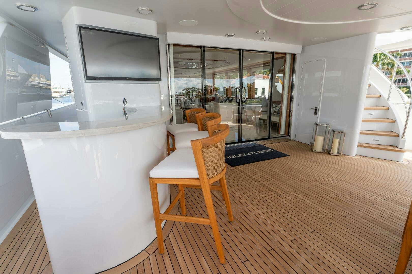 a room with a tv and a table aboard RELENTLESS Yacht for Sale