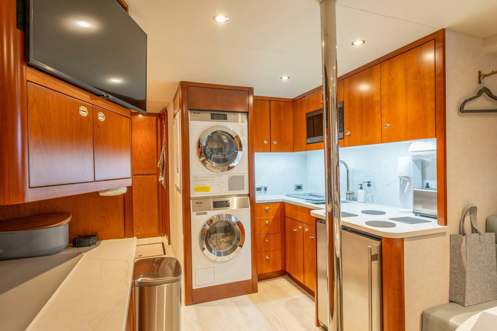 a kitchen with wooden cabinets aboard RELENTLESS Yacht for Sale