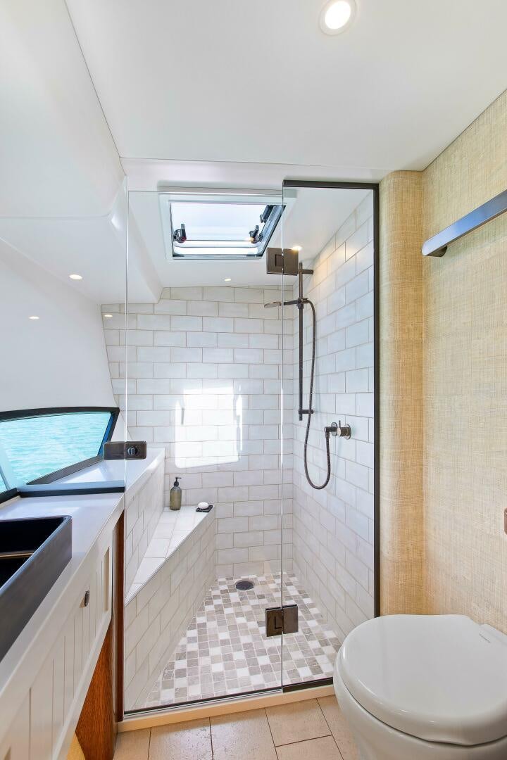 a bathroom with a shower unit and a toilet aboard THE KEYS Yacht for Sale