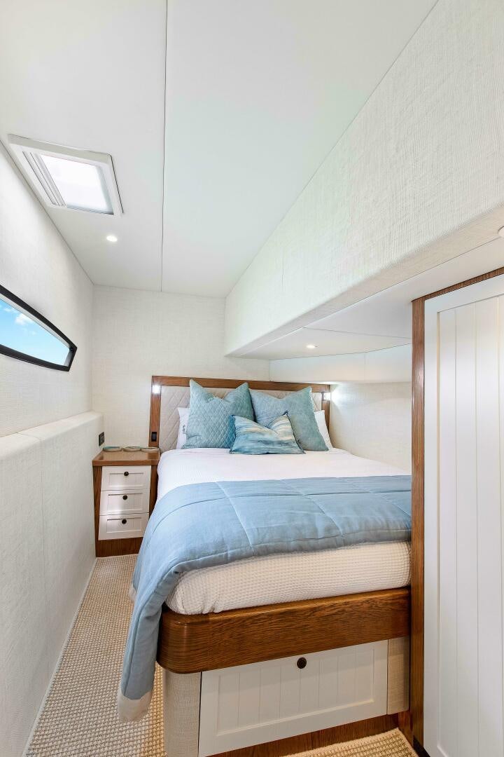 a bed with a blue comforter aboard THE KEYS Yacht for Sale