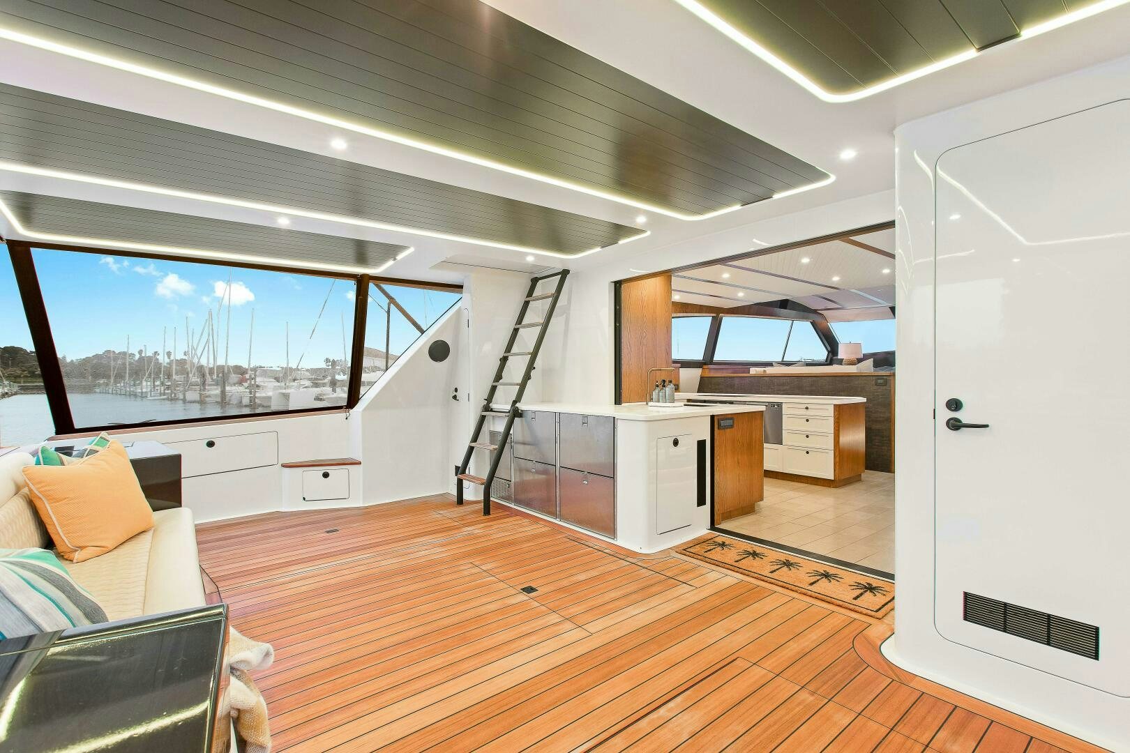 a room with a wood floor and a large window with a view of the city aboard THE KEYS Yacht for Sale