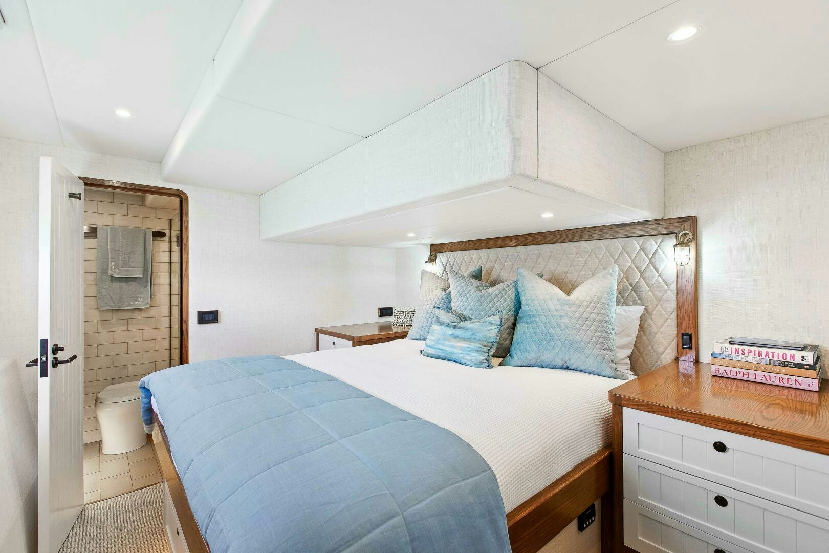 a bedroom with a bed and a dresser aboard THE KEYS Yacht for Sale