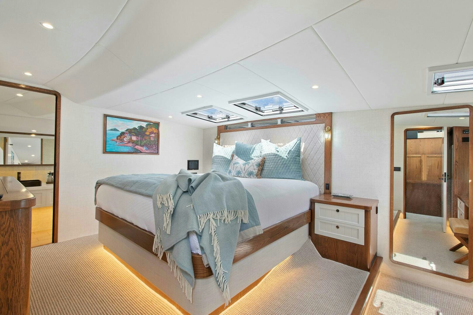 a bedroom with a bed and a desk aboard THE KEYS Yacht for Sale