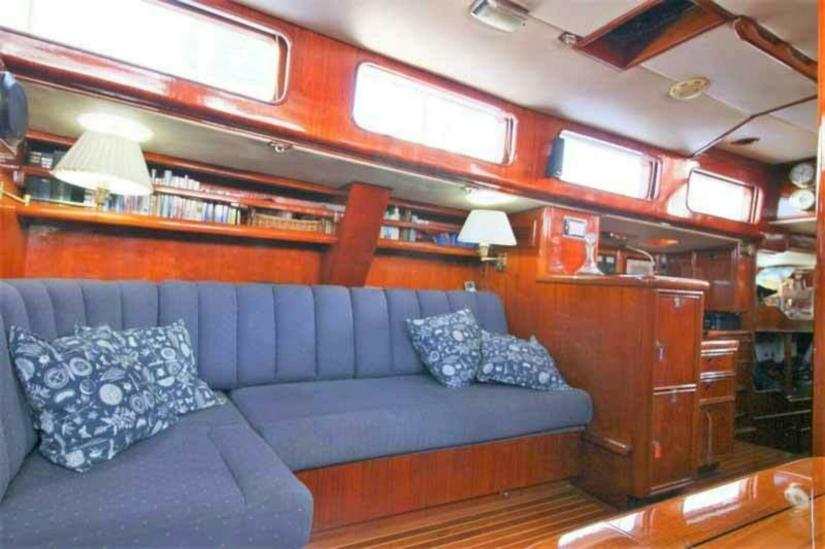 a blue couch in a room aboard KOKOMO VI Yacht for Sale