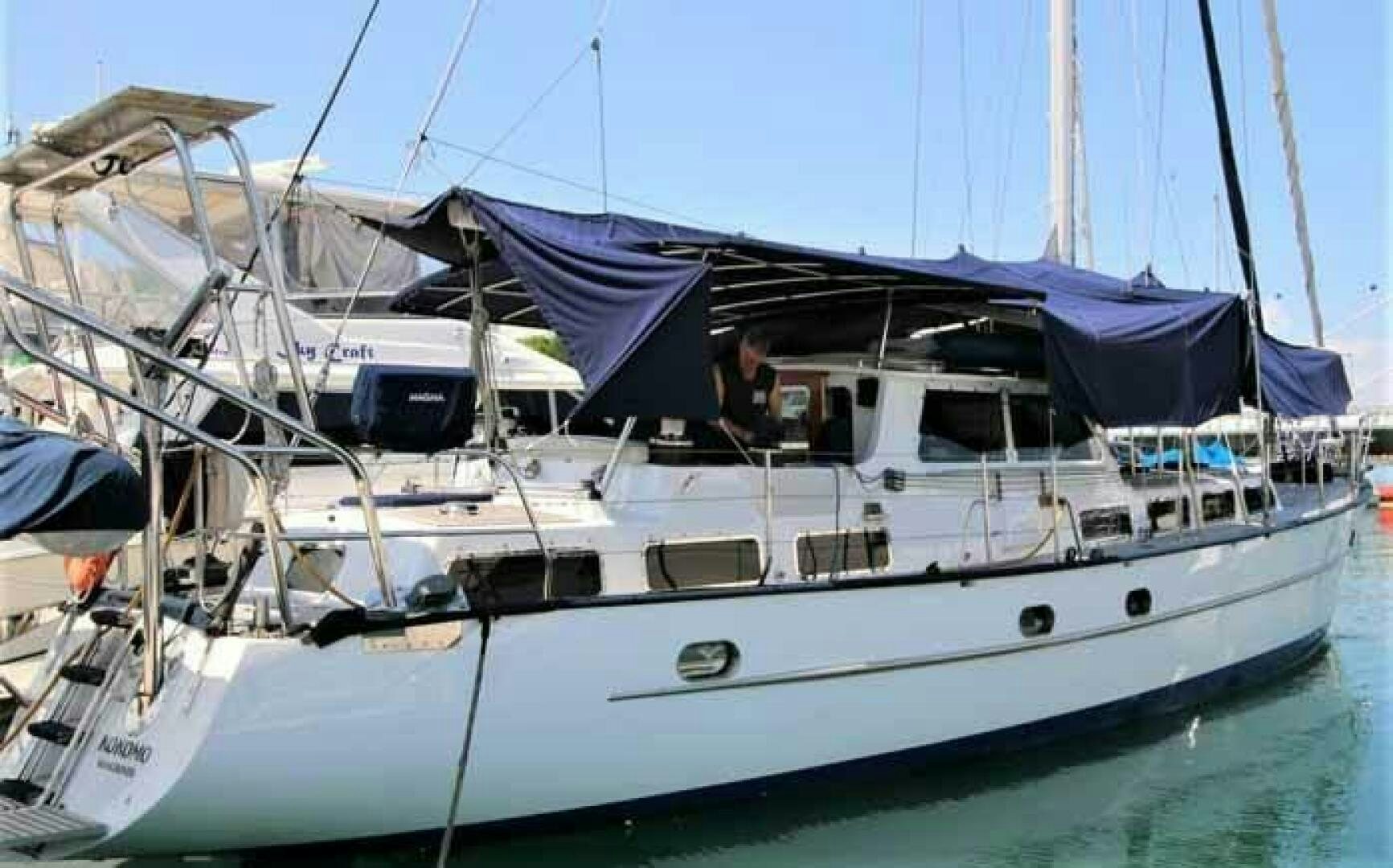 a boat with a blue roof aboard KOKOMO VI Yacht for Sale