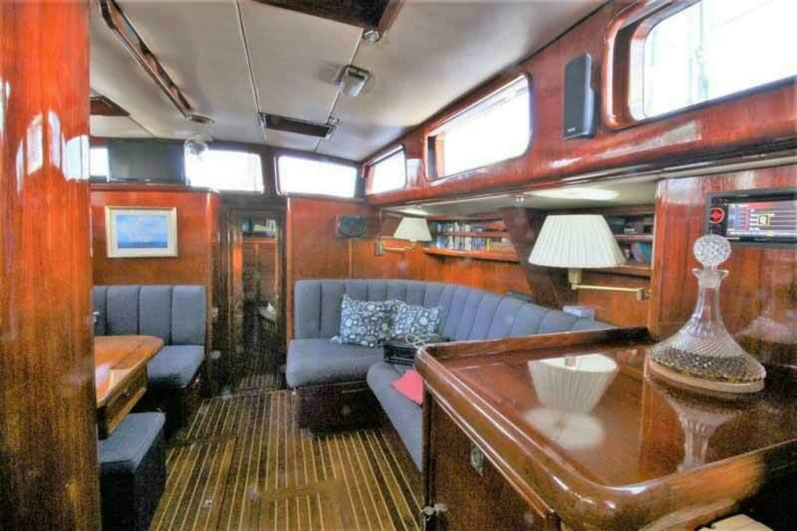 a living room with a couch and a table aboard KOKOMO VI Yacht for Sale