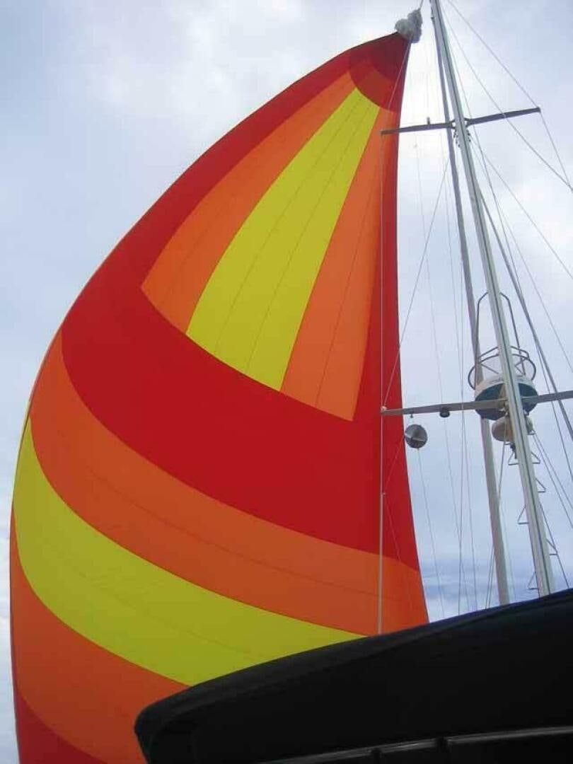a colorful sailboat on the water aboard KOKOMO VI Yacht for Sale