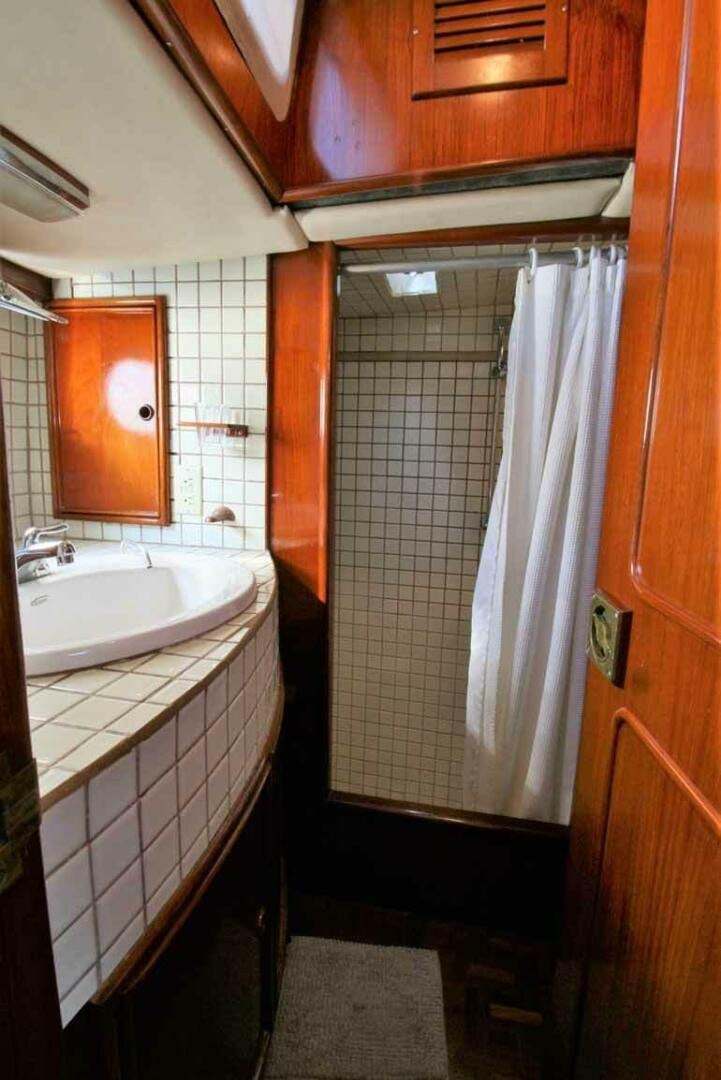 a bathroom with a sink and a shower aboard KOKOMO VI Yacht for Sale