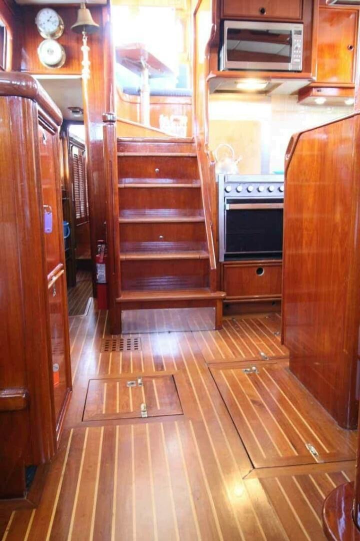 a kitchen with wooden cabinets aboard KOKOMO VI Yacht for Sale