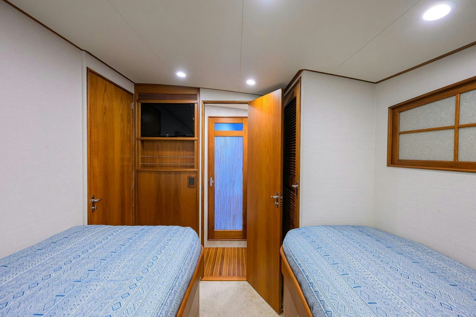 a bedroom with two beds aboard PERSISTENCE Yacht for Sale