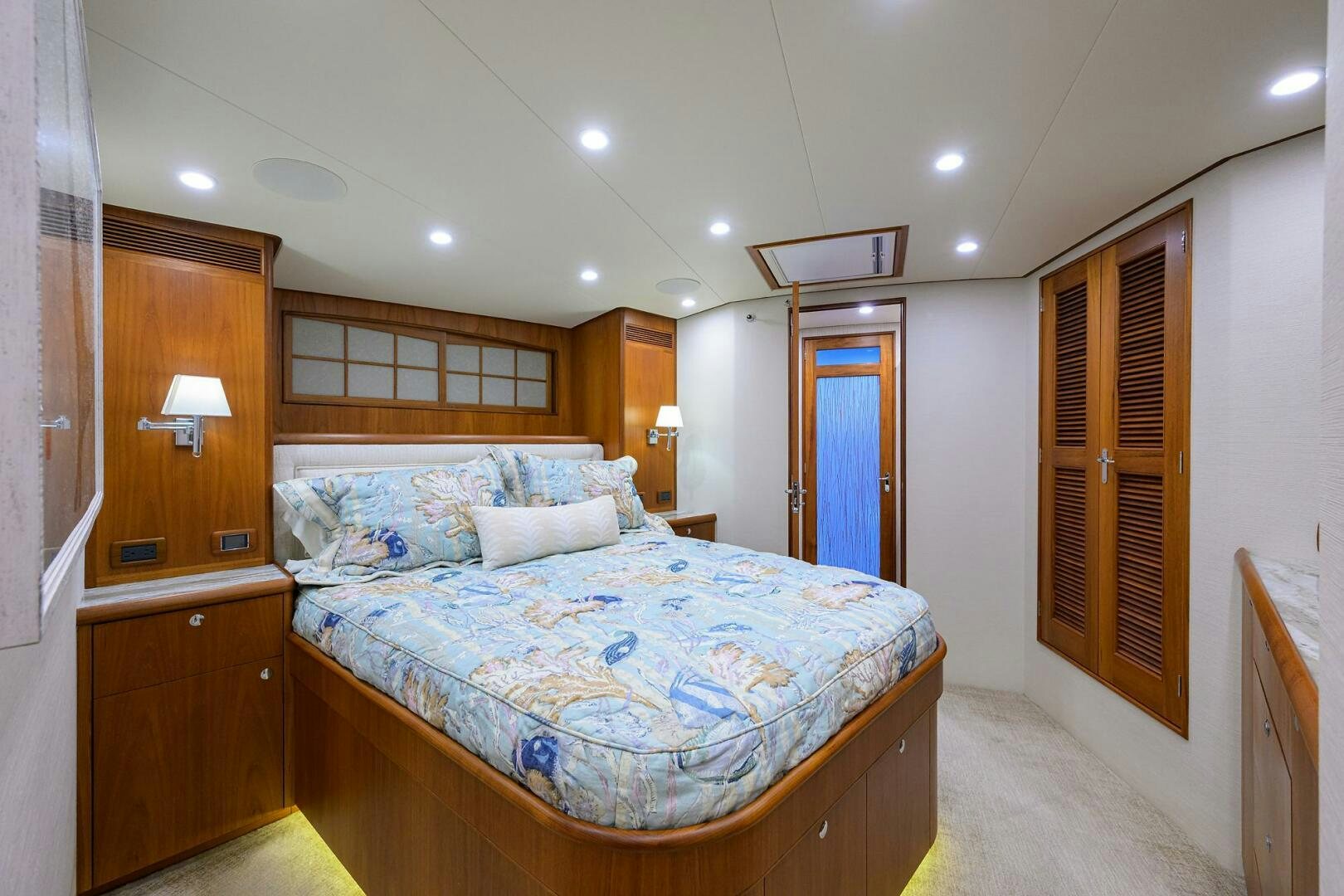a bedroom with a bed and a closet aboard PERSISTENCE Yacht for Sale