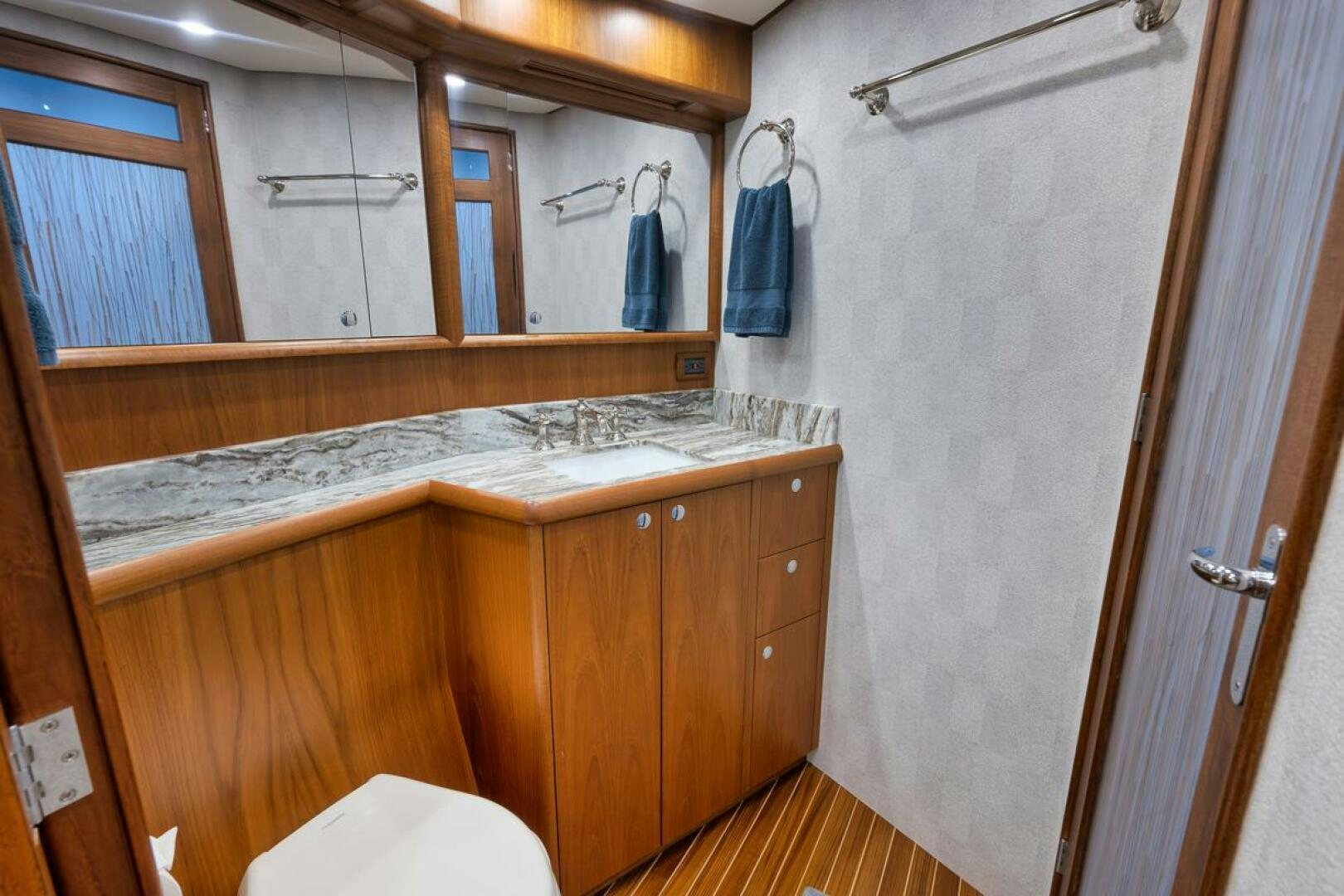 a bathroom with a countertop sink and mirror aboard PERSISTENCE Yacht for Sale