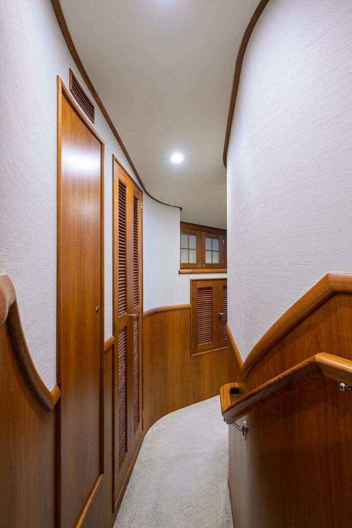 a bedroom with a bed and a closet aboard PERSISTENCE Yacht for Sale