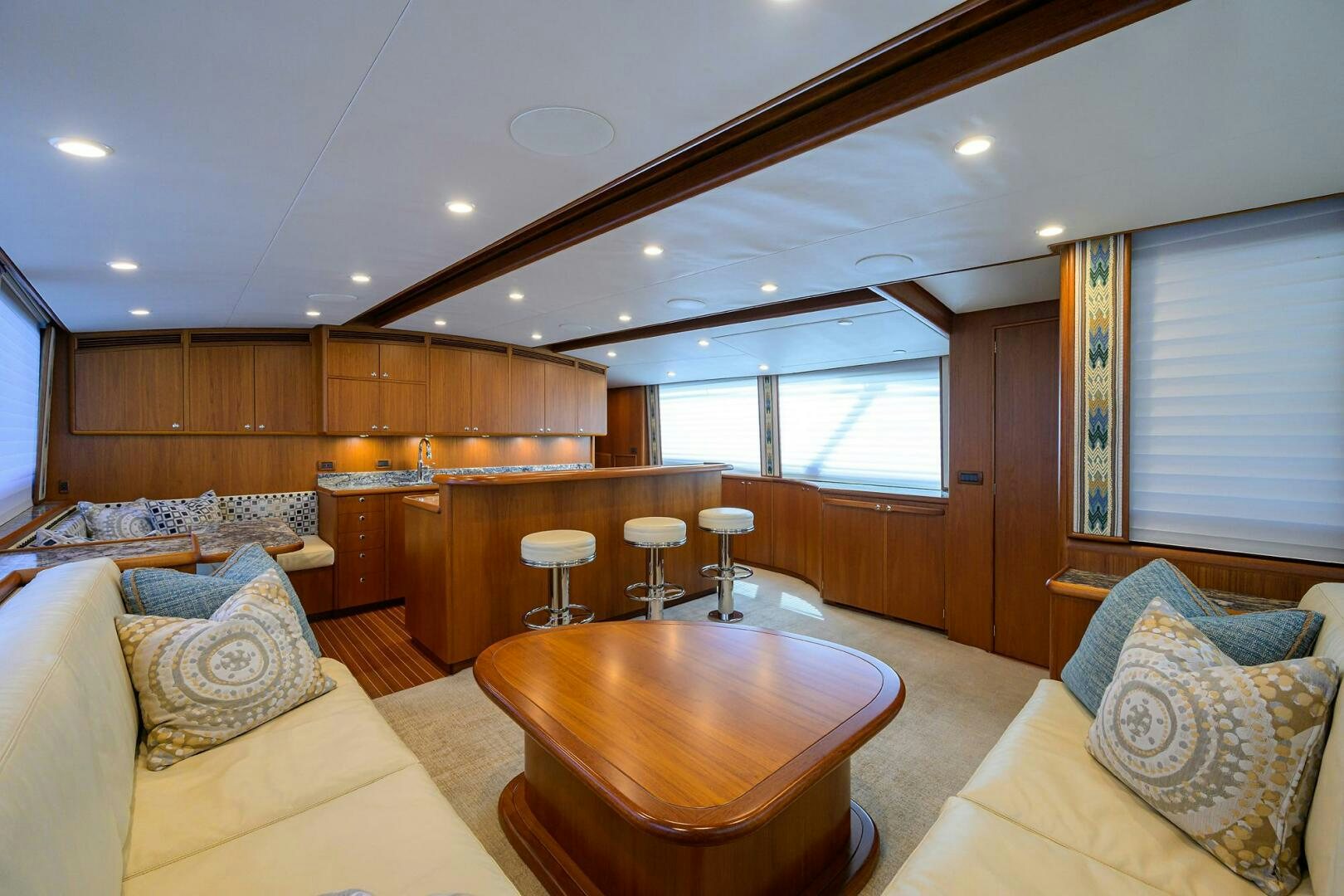 a living room with wood cabinets aboard PERSISTENCE Yacht for Sale