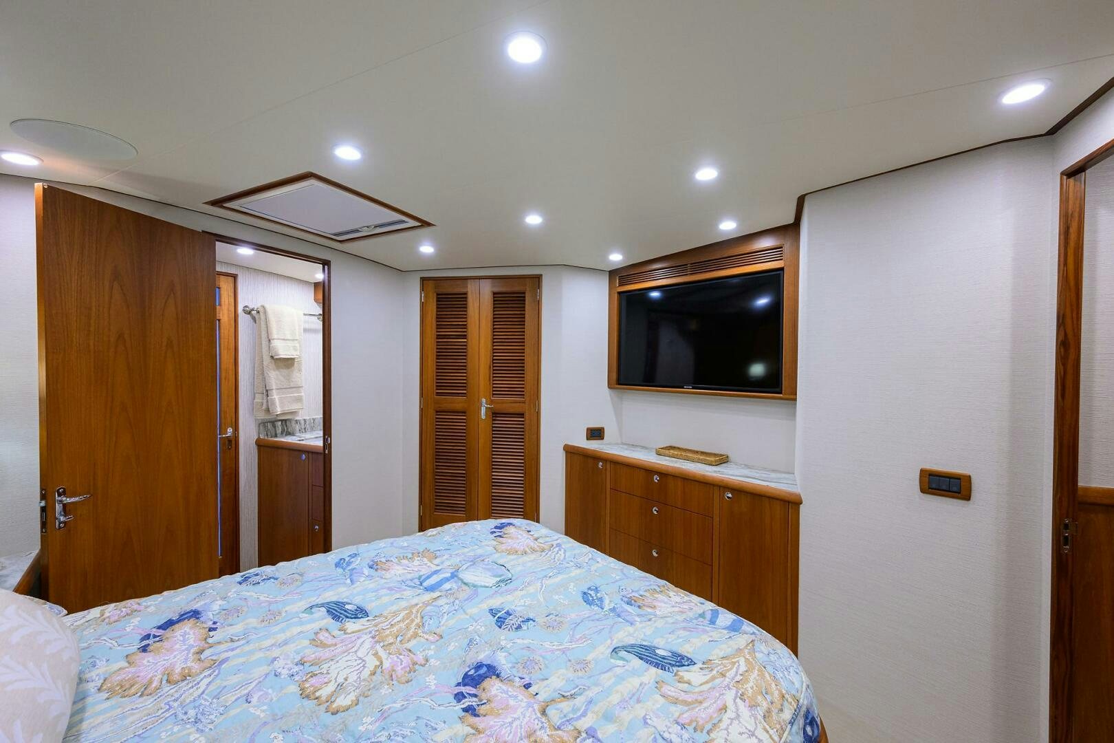 a bedroom with a bed and television aboard PERSISTENCE Yacht for Sale