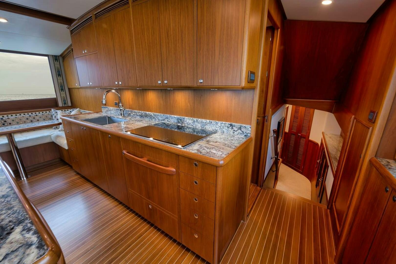 a kitchen with wooden cabinets aboard PERSISTENCE Yacht for Sale