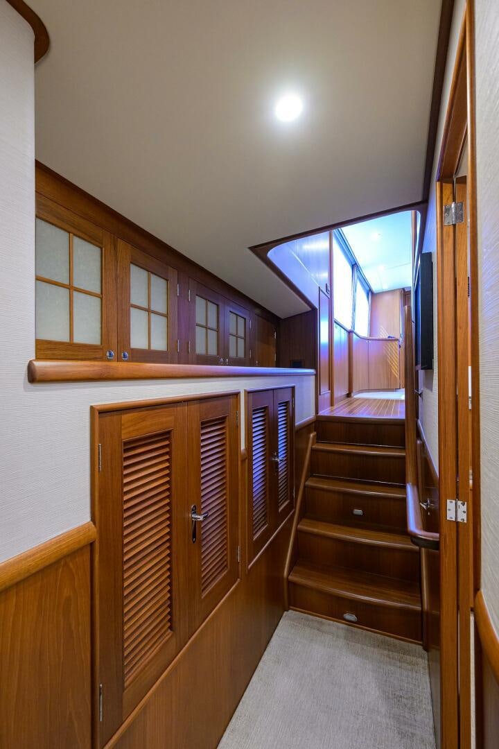 a room with a wood cabinet and a mirror aboard PERSISTENCE Yacht for Sale