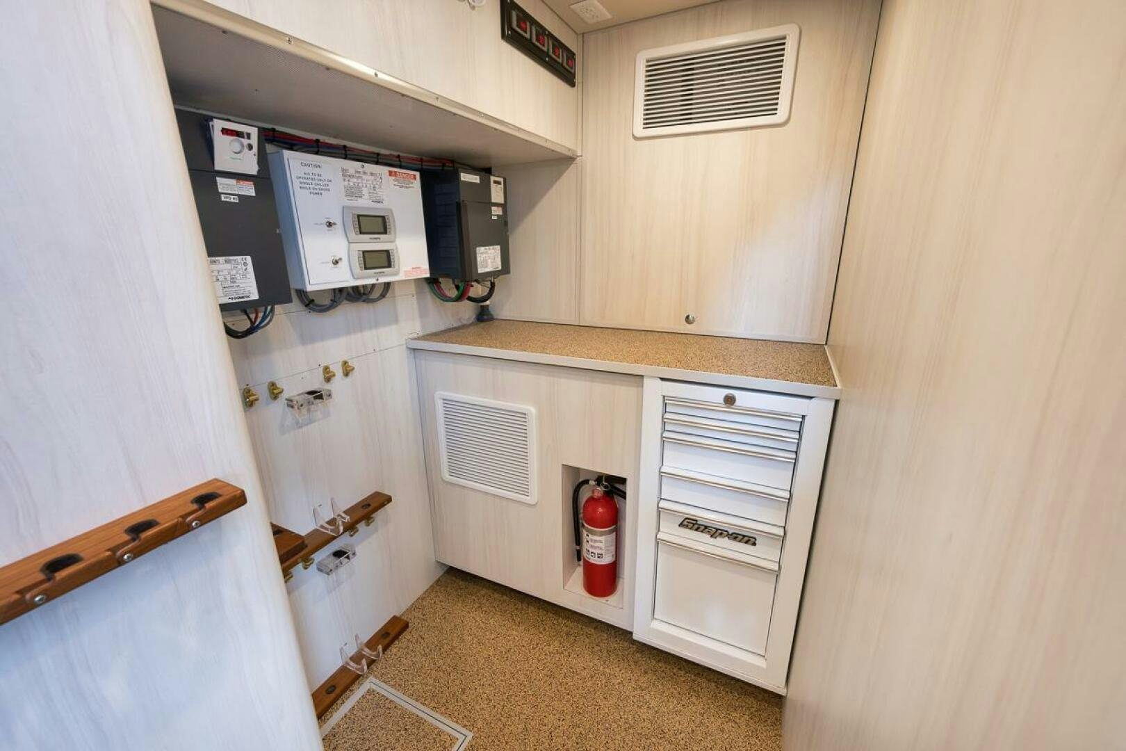 a small kitchen with a small refrigerator aboard PERSISTENCE Yacht for Sale