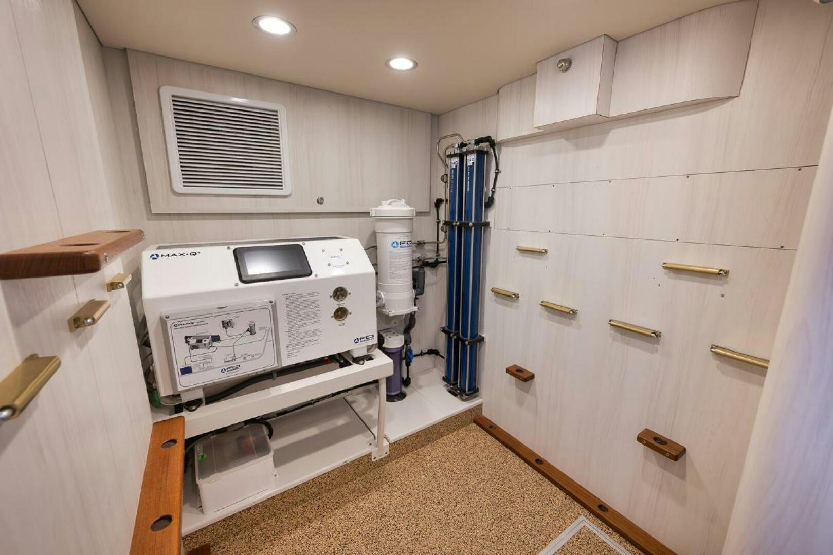 a room with a machine and a heater aboard PERSISTENCE Yacht for Sale