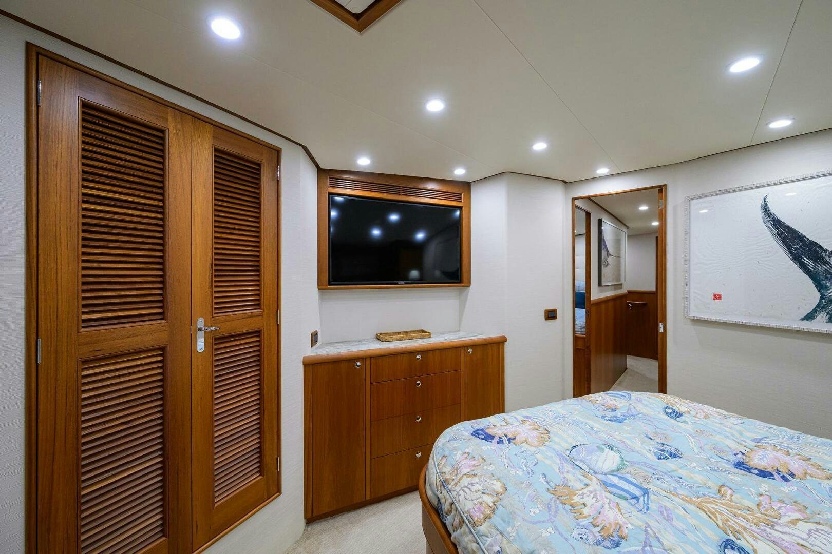 a bedroom with a bed and a television aboard PERSISTENCE Yacht for Sale