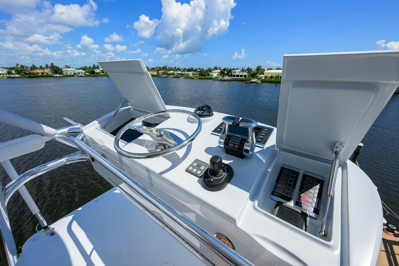 a boat with a steering wheel and a boat on the water aboard PERSISTENCE Yacht for Sale