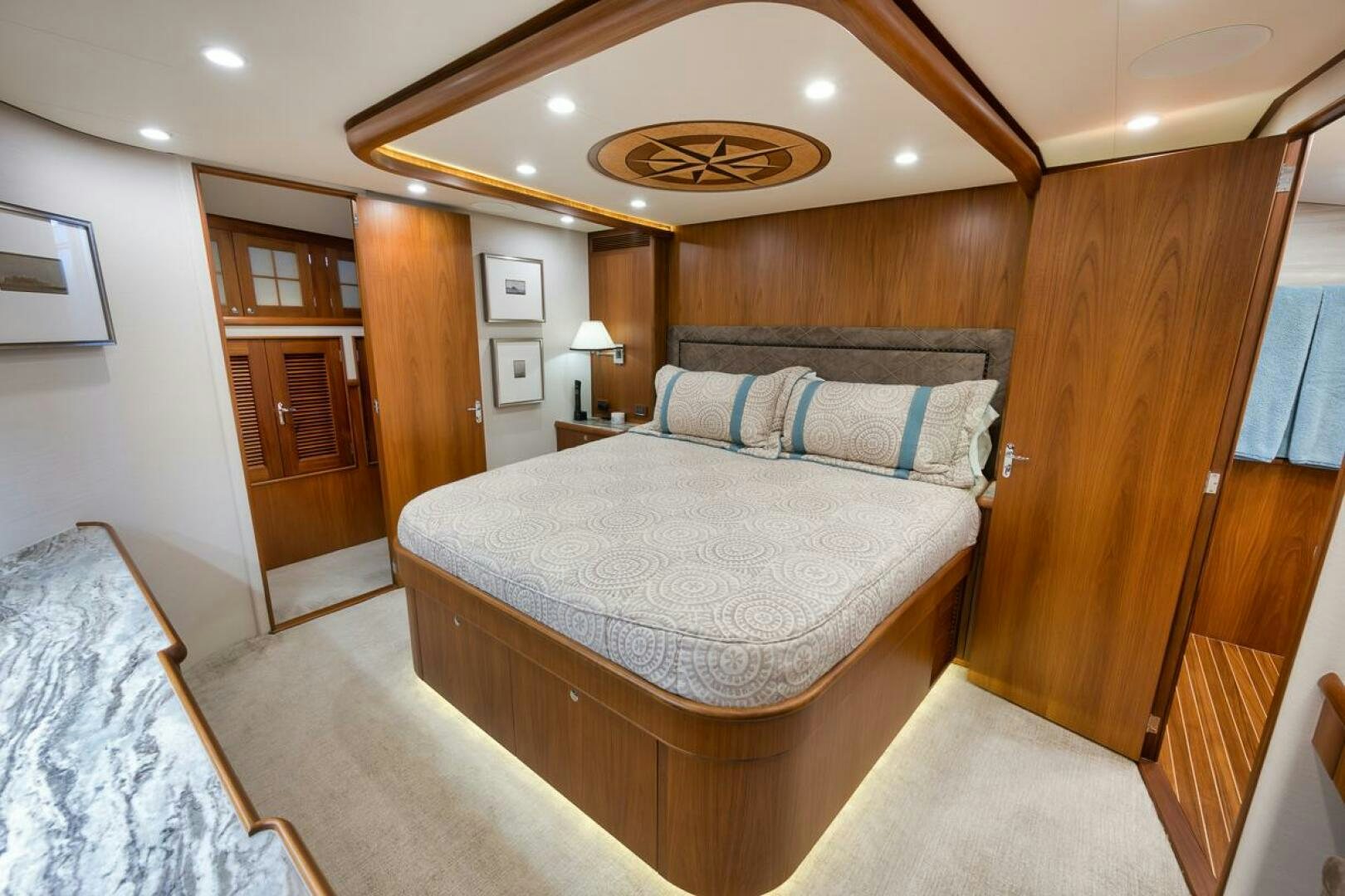 a bedroom with a bed and a mirror aboard PERSISTENCE Yacht for Sale