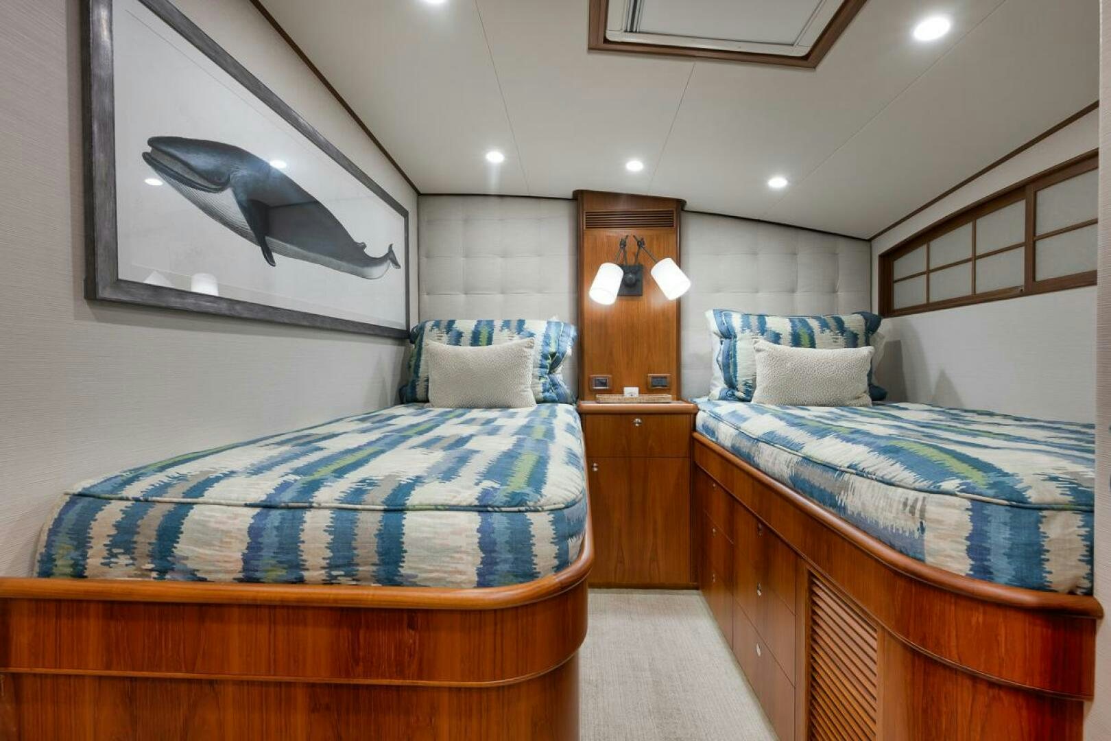 a bedroom with two beds aboard PERSISTENCE Yacht for Sale