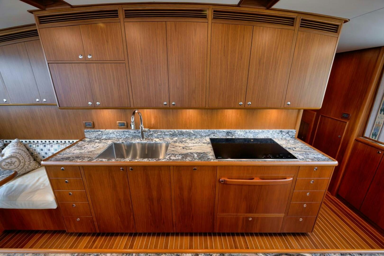 a kitchen with wooden cabinets aboard PERSISTENCE Yacht for Sale