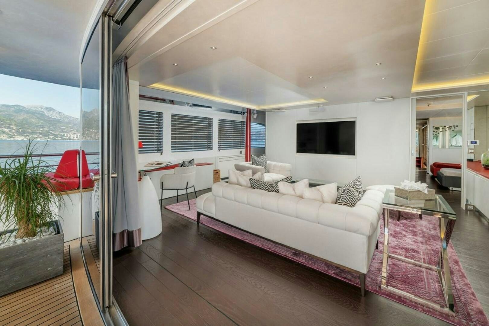 a living room with a large window aboard JOY ME Yacht for Sale