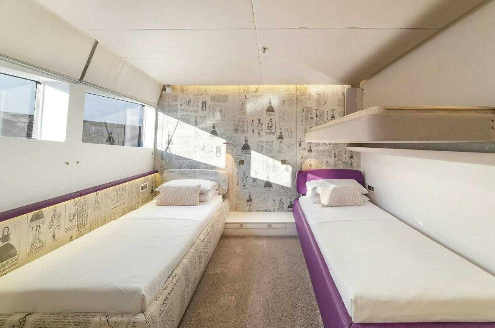 a room with beds and a window aboard JOY ME Yacht for Sale