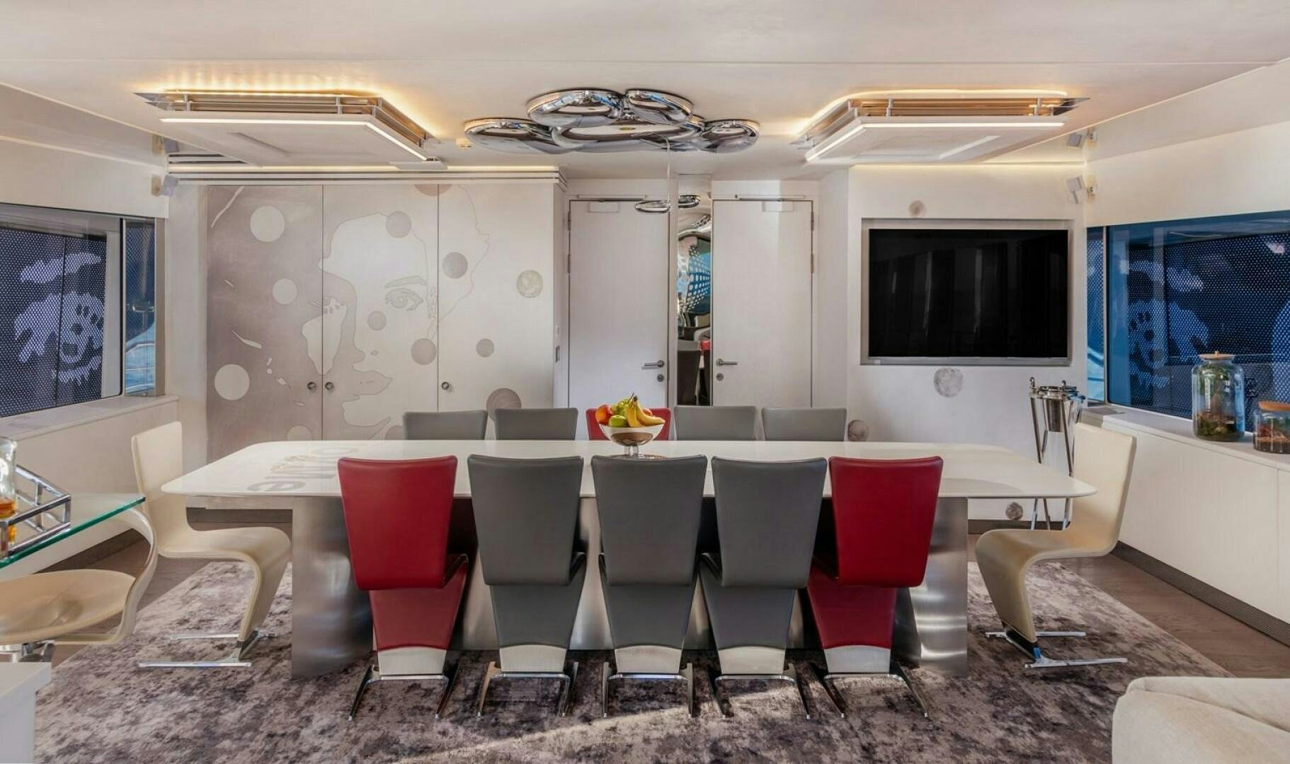 a room with chairs and a table aboard JOY ME Yacht for Sale