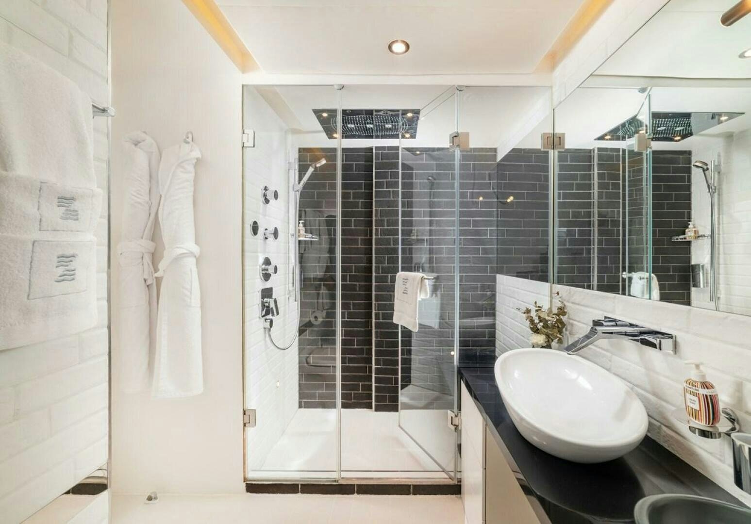 a bathroom with a glass shower aboard JOY ME Yacht for Sale