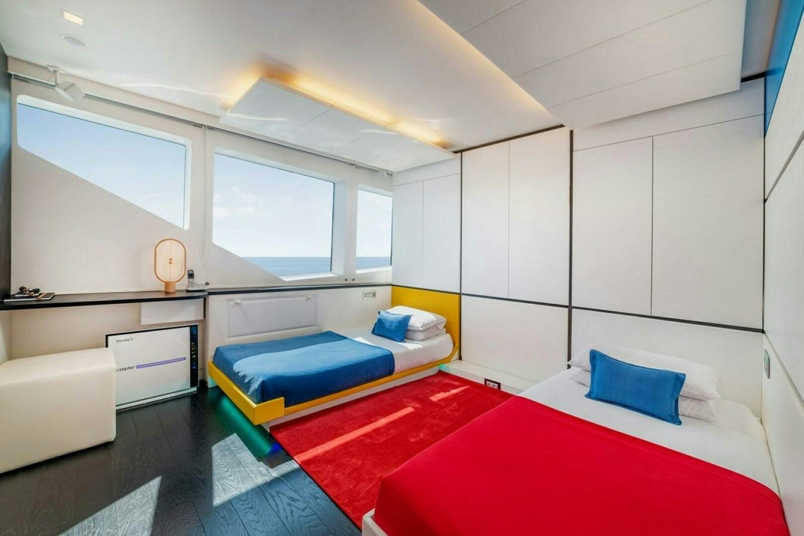 a room with a red rug and white walls aboard JOY ME Yacht for Sale