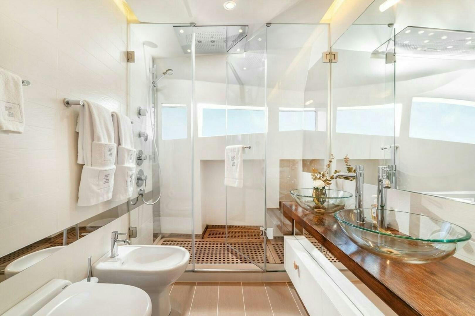 a bathroom with a large mirror aboard JOY ME Yacht for Sale