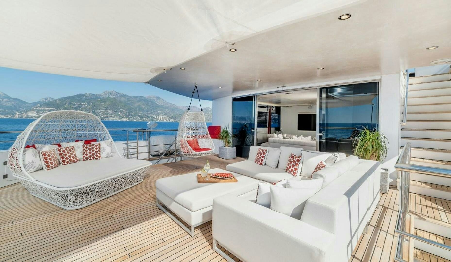 a large white room with a large bed and a large window aboard JOY ME Yacht for Sale