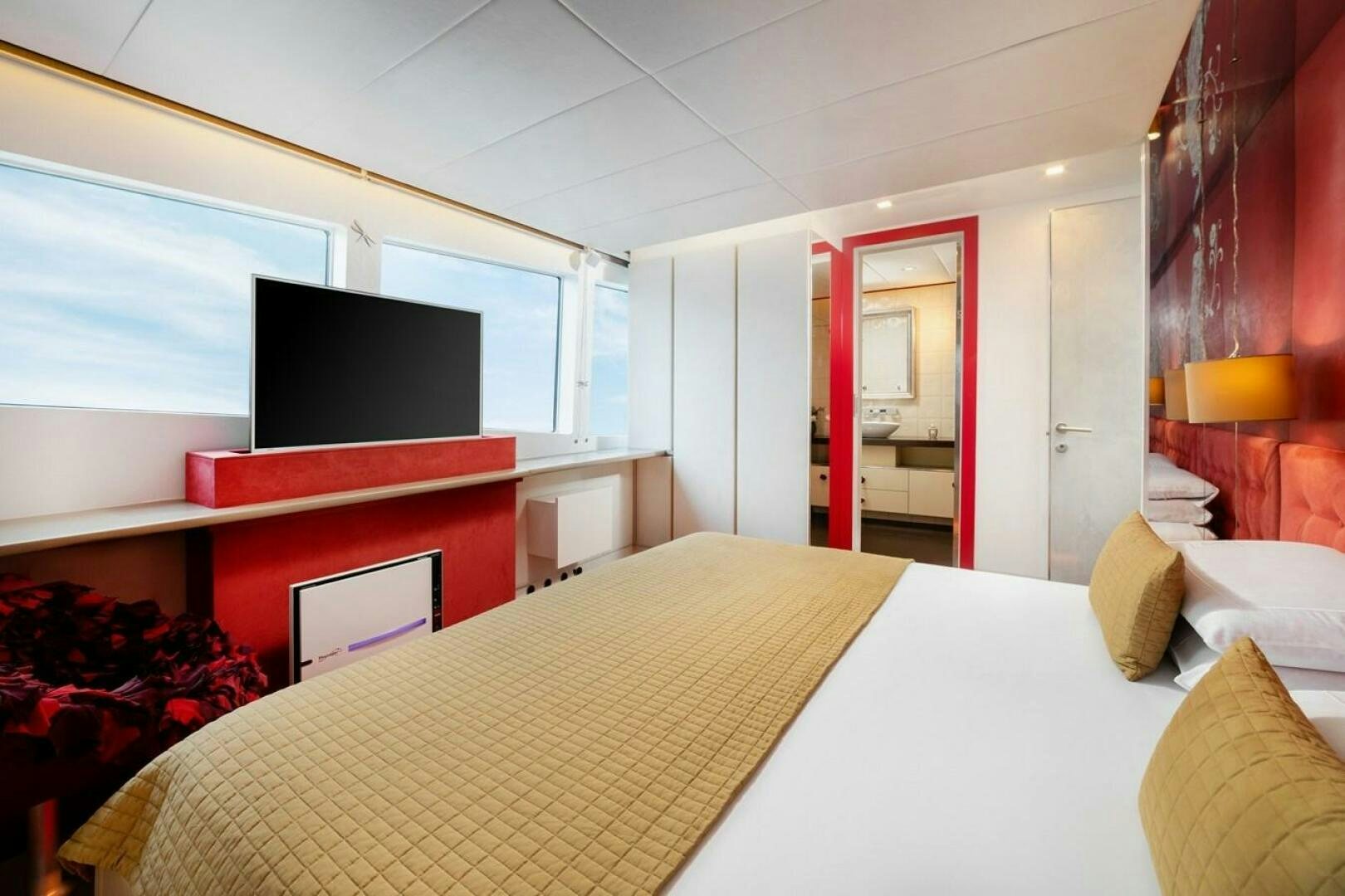 a hotel room with a large bed aboard JOY ME Yacht for Sale