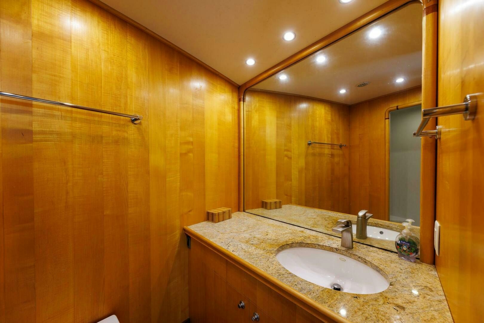 a bathroom with a countertop sink and a mirror aboard STRESS RELIEFF  Yacht for Sale