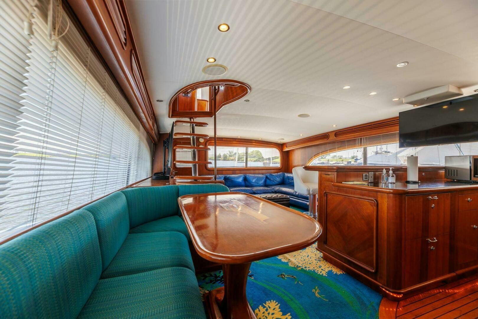 a living room with a table and couches aboard STRESS RELIEFF  Yacht for Sale