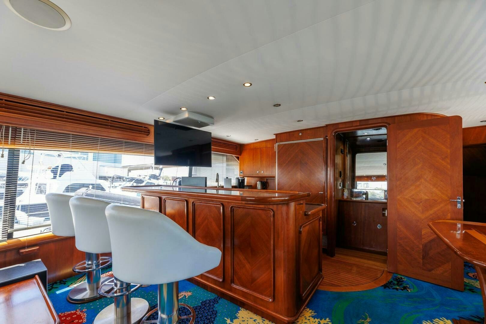 a kitchen with a bar and a table and chairs aboard STRESS RELIEFF  Yacht for Sale