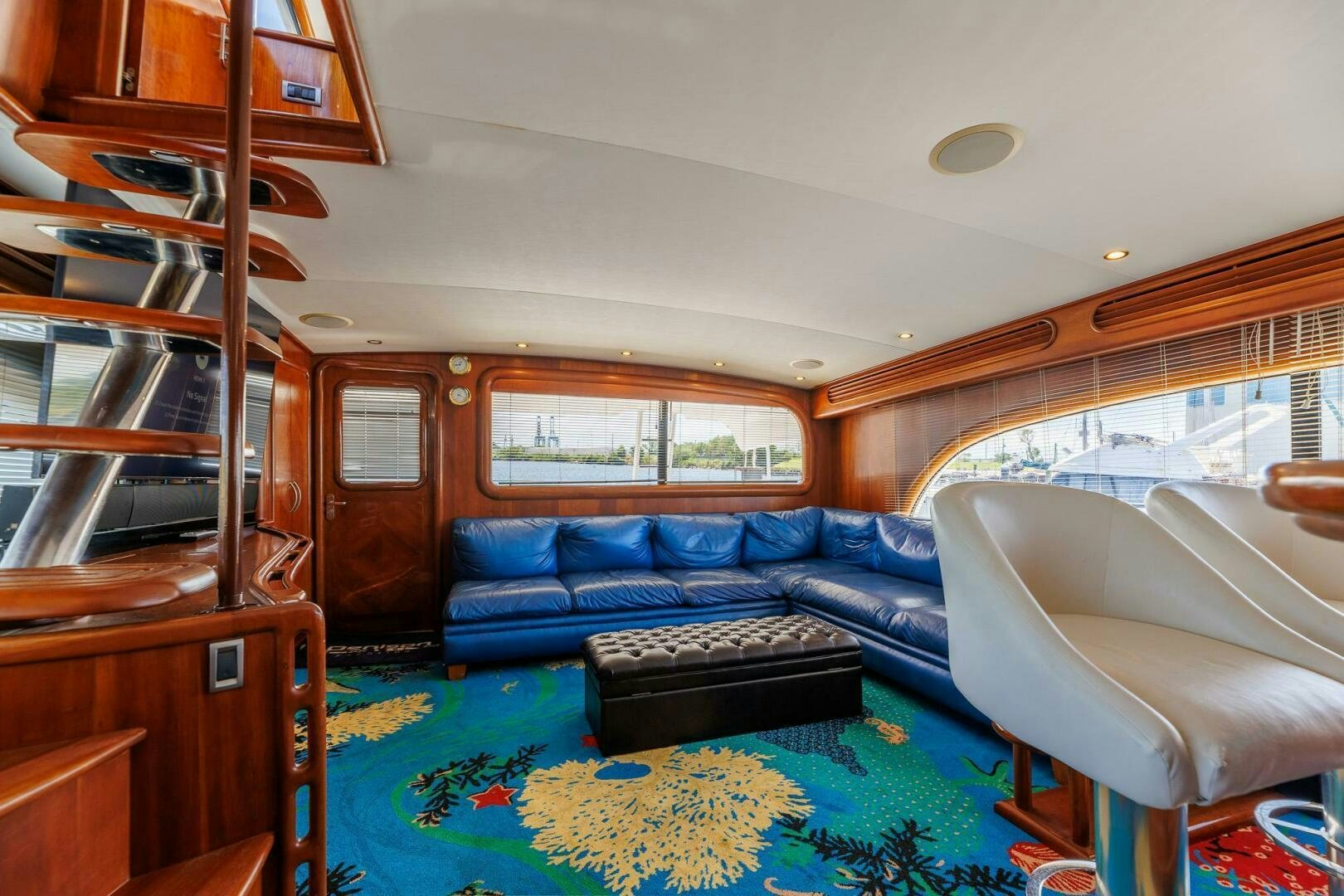 a living room with a blue couch aboard STRESS RELIEFF  Yacht for Sale