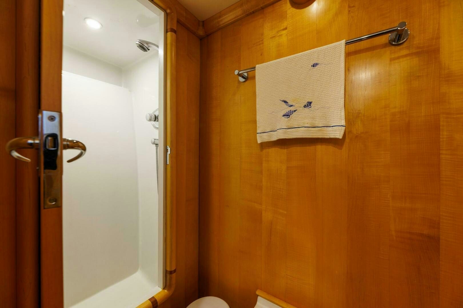 a bathroom with a wood door aboard STRESS RELIEFF  Yacht for Sale