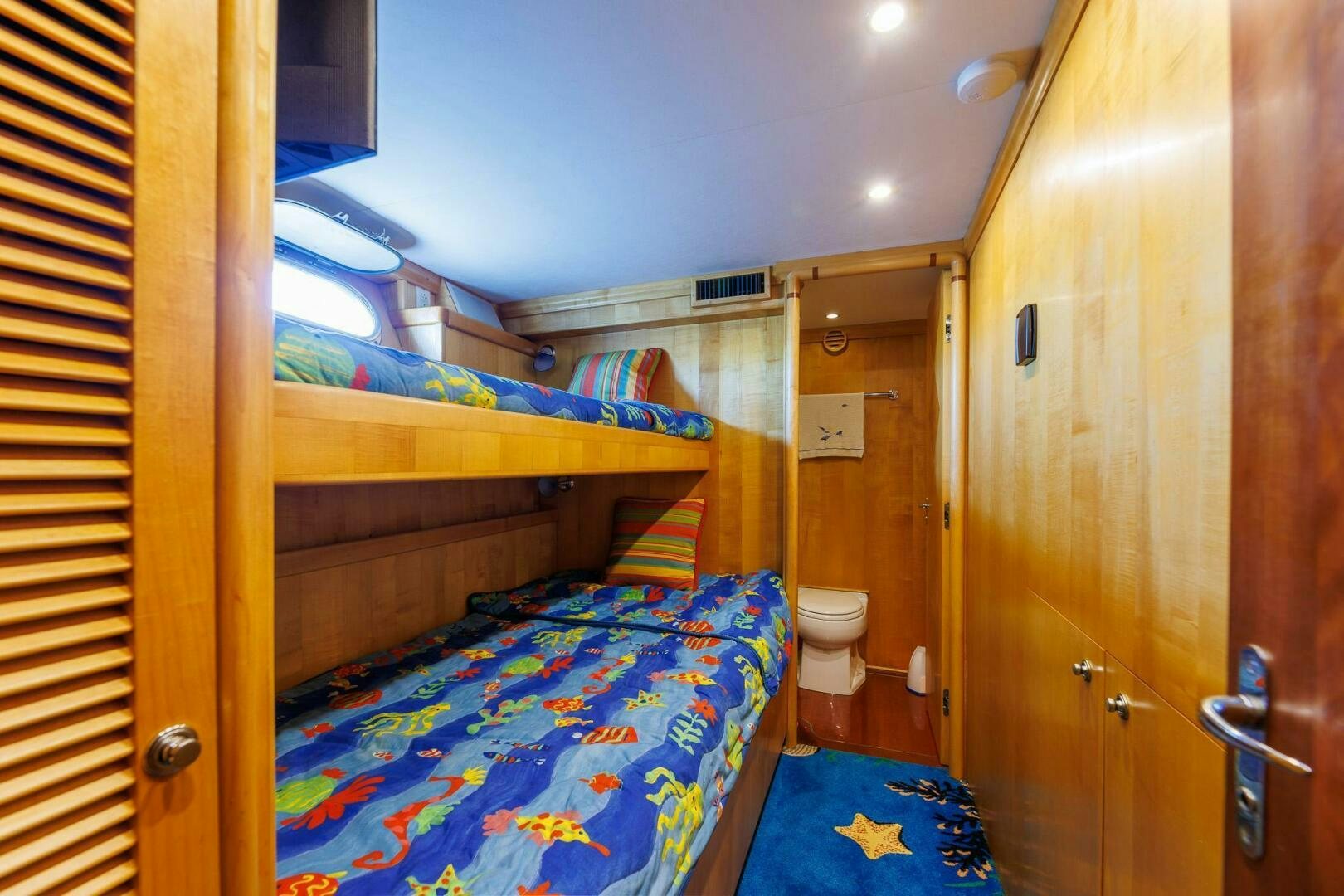 a small bedroom with a double bed aboard STRESS RELIEFF  Yacht for Sale